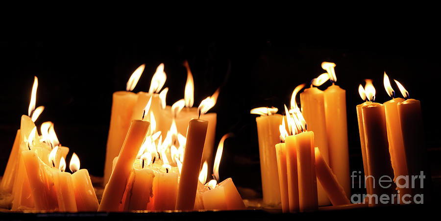 Religious candle light on black background. Yellow candlelight f Photograph by Jelena Jovanovic
