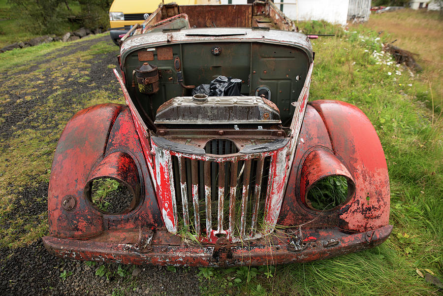 Remains of an old red car in Seydisfjordur Photograph by RicardMN Photography