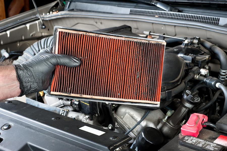 Removing a dirty automotive air filter Photograph by Joebelanger