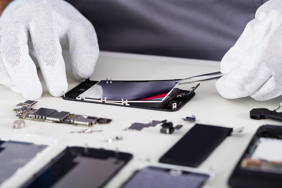 Repairman Disassembling Smartphone With Tweezers Photograph by AndreyPopov