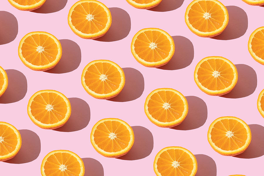 Repeated orange on the pink background Photograph by Yulia Reznikov