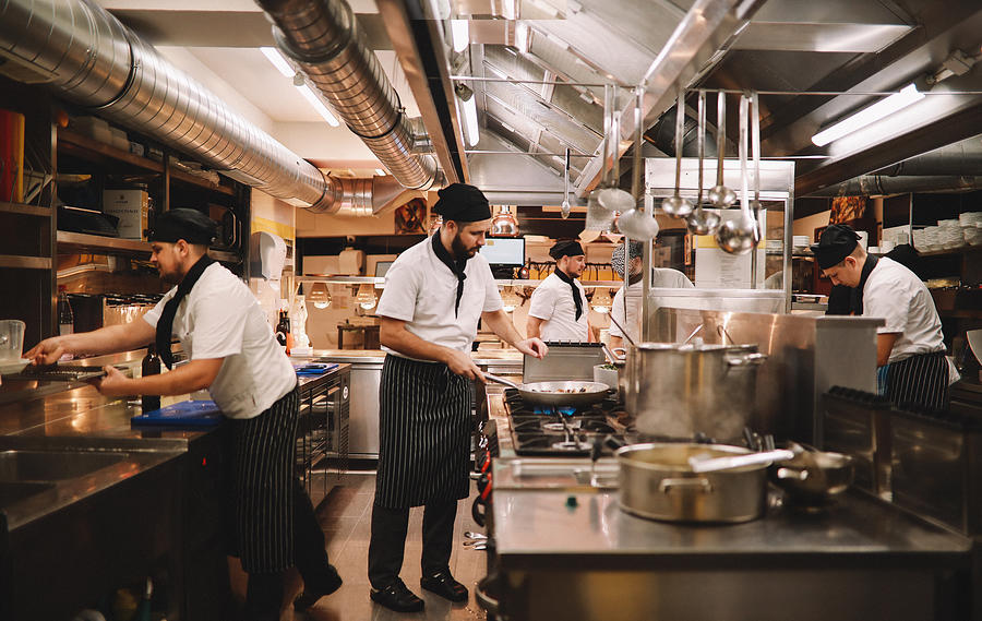 Restaurant kitchen crew in action Photograph by Lechatnoir