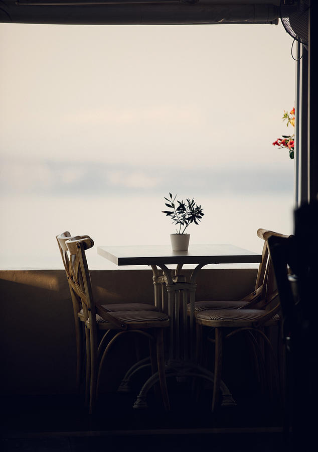 Restaurant table close to the sea Photograph by Thepalmer