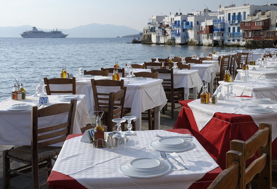 Restaurant Tables and Venetian houses in Mykonos, Greece Photograph by Tunart