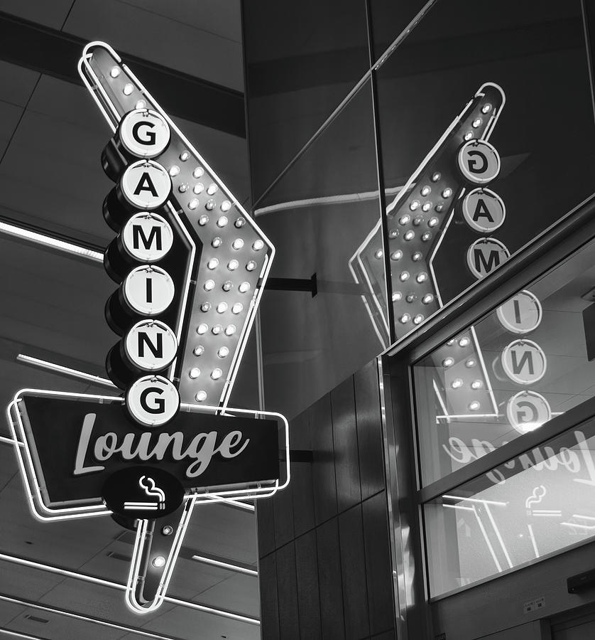 Retro Flying V Neon Gaming Lounge Sign and Reflection McCarran Airport Las Vegas Black and White Photograph by Shawn OBrien