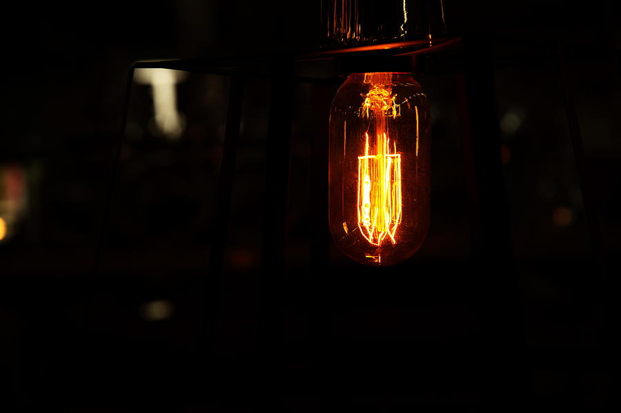 Retro Light Bulb In The Dark Background At Night Photograph by MadamLead