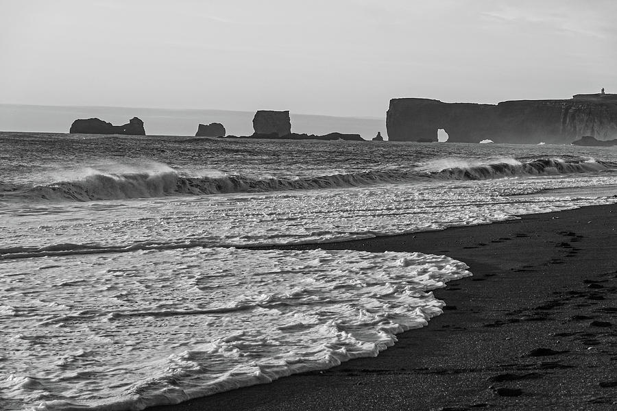 Reynisfjara Black Sand Beach in Iceland looking at Dyrholaey at Sunset Black and White Photograph by Toby McGuire