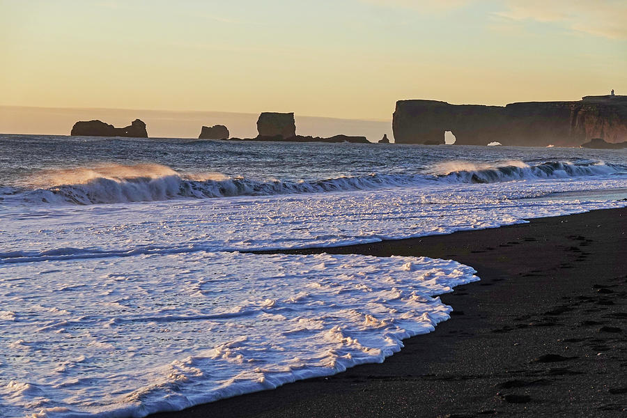 Reynisfjara Black Sand Beach in Iceland looking at Dyrholaey at Sunset Photograph by Toby McGuire