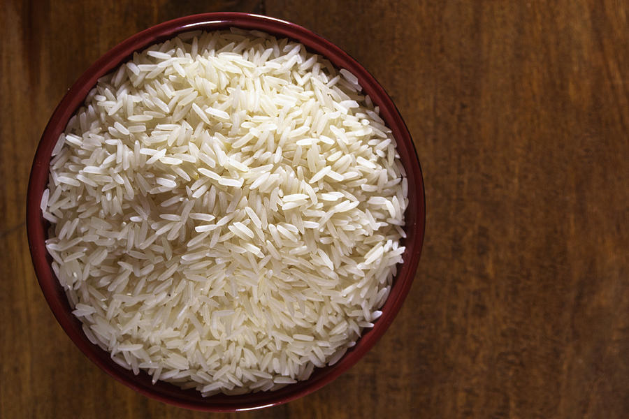 Rice in a wooden bowl Photograph by Antonio Ciufo