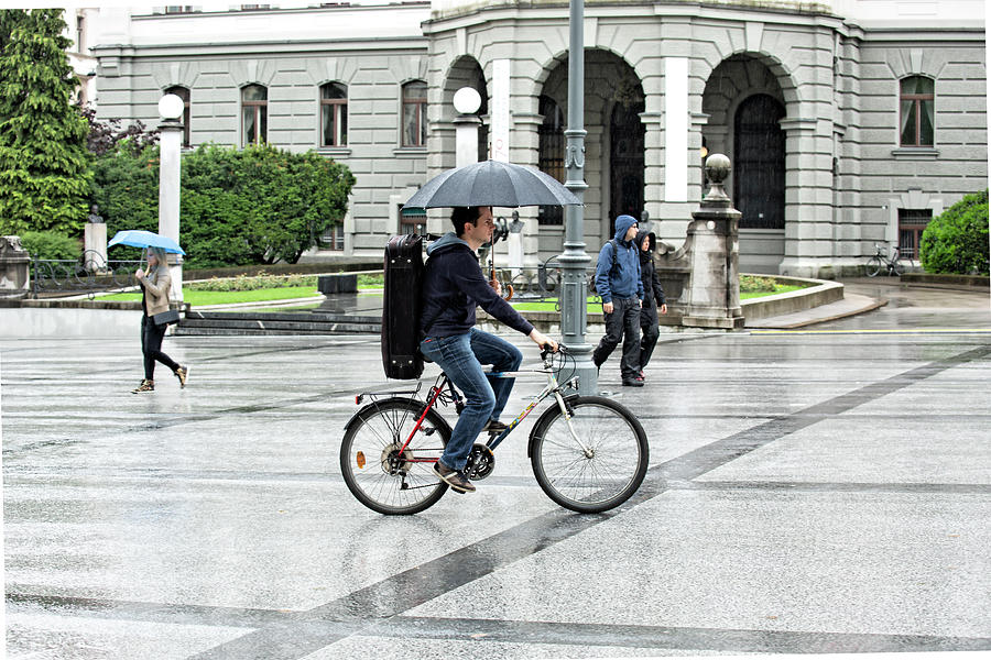 Riding a Bike in the Rain Photograph by Lindley Johnson