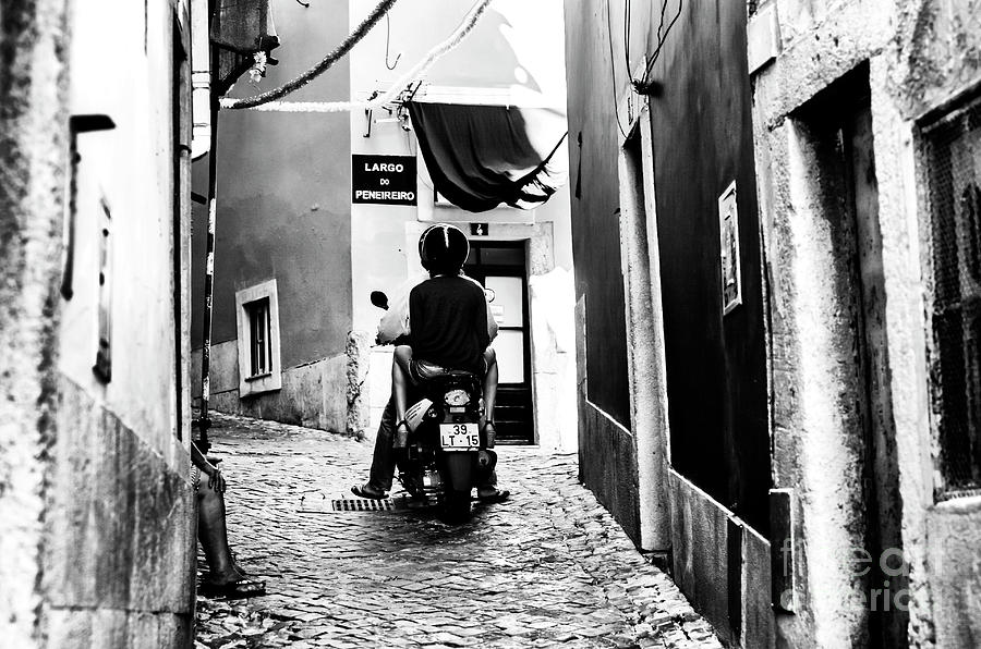 Riding a Scooter in Alfama Lisbon Photograph by John Rizzuto