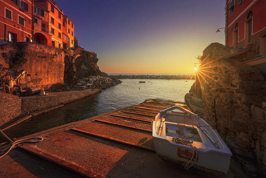 Riomaggiore village, a boat in front of the sea at sunset. Cinqu Photograph by Stefano Orazzini