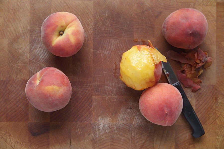 Ripe summer peaches, one peeled Photograph by Nebari
