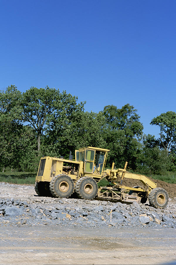 Road building grader at construction site Photograph by Comstock Images