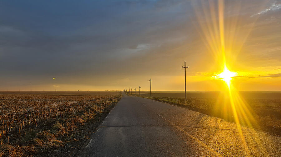 Sunset Photograph - Road Stretches Toward The Horizon by Adriana Gheorghe