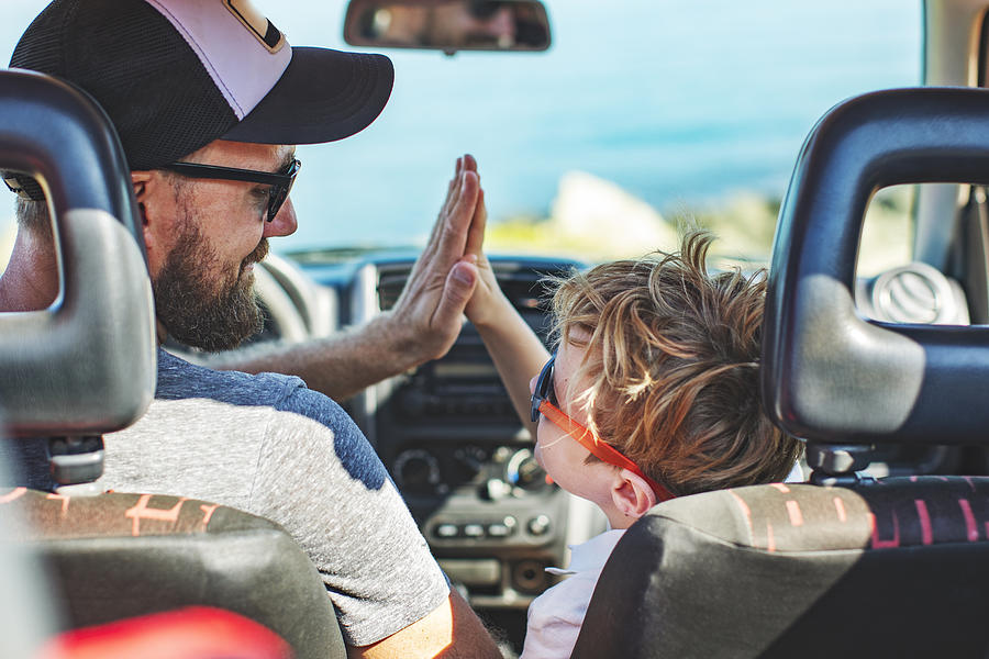 Road trip. Father and son travelling together by car Photograph by Yulkapopkova