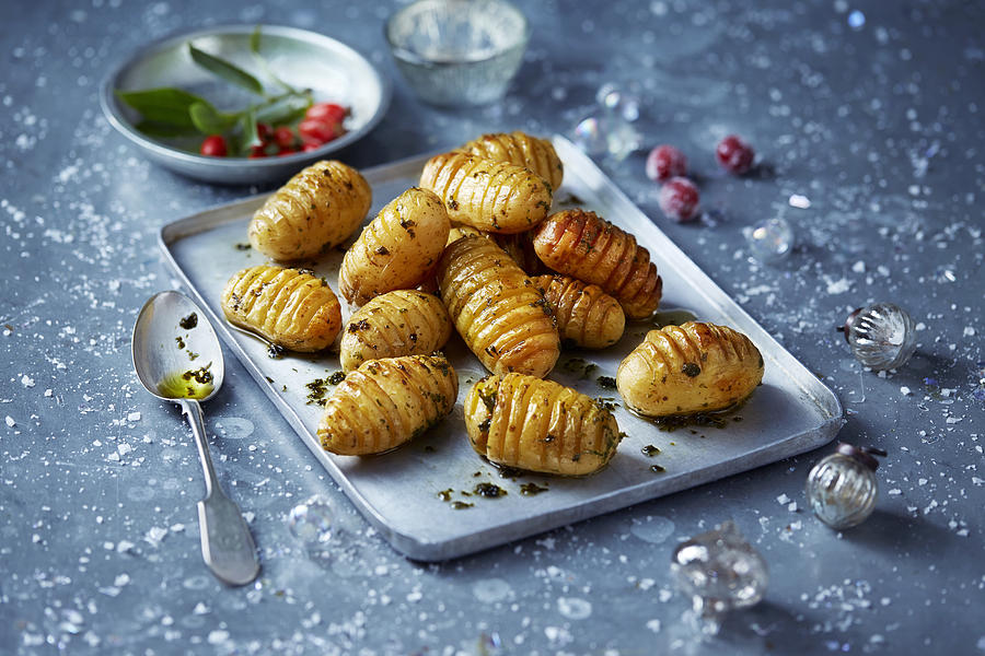Roast potatoes on baking tray, Christmas food Photograph by Danielle Wood