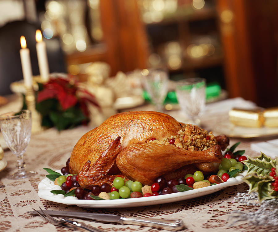 Roast turkey on dinner table Photograph by Stockbyte