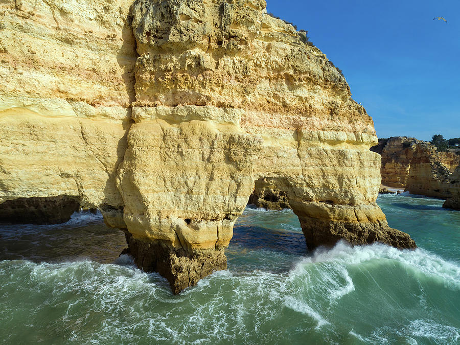 Rock cliffs and waves in Algarve Photograph by Mikhail Kokhanchikov