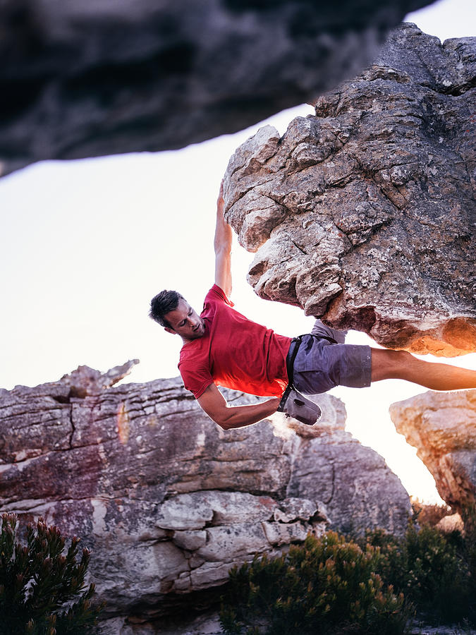 Rock climber with hand in chalk bag hanging on boulder Photograph by Wundervisuals