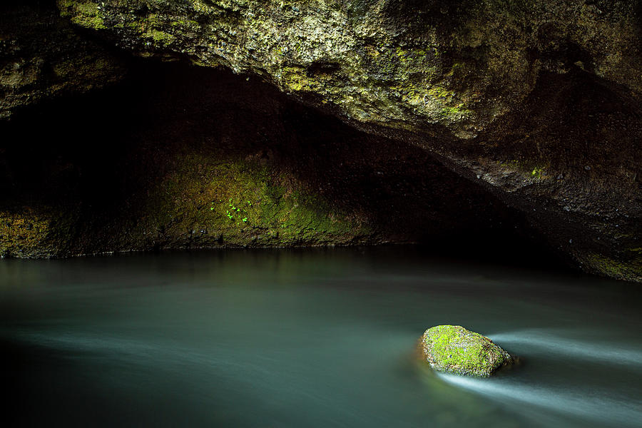 Rock in a cave stream Photograph by Ruben Vicente
