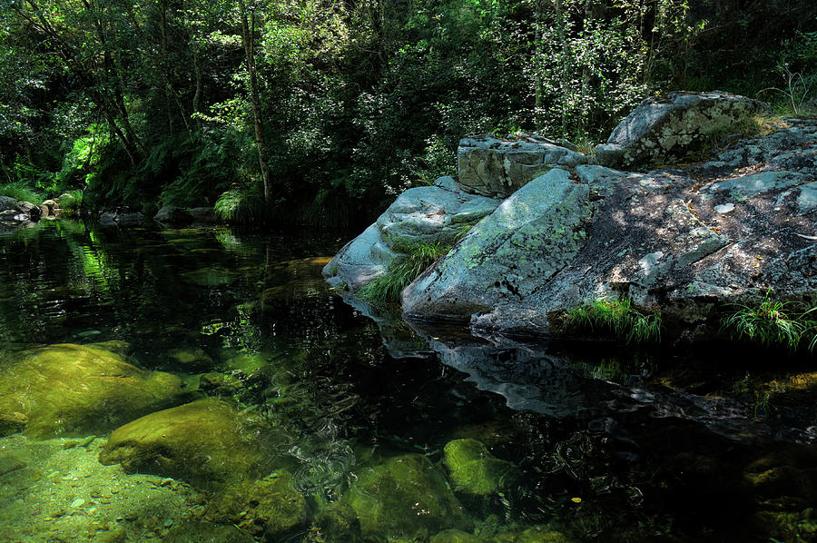Rocks and peaceful river in Carvalhais Photograph by Angelo DeVal