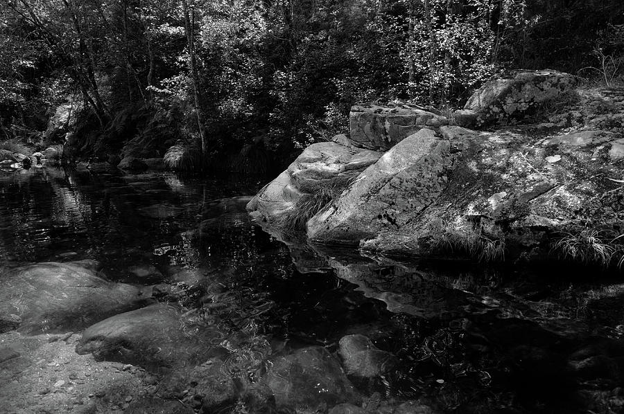 Rocks and peaceful river in Carvalhais with monochrome Photograph by Angelo DeVal