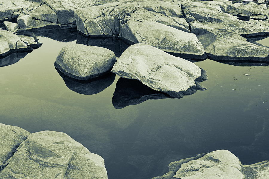 Rocks are reflected in the glassy water of a coastal puddle - duotone Photograph by Ulrich Kunst And Bettina Scheidulin