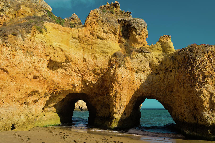 Rocky Arches in Three Brothers beach. Algarve, Portugal Photograph by Angelo DeVal