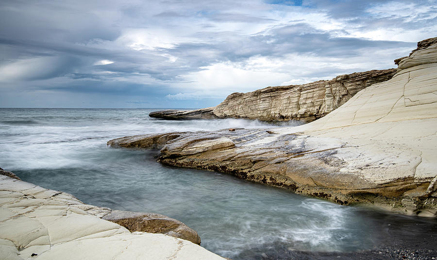 Rocky seacoast and waves splashing on  with white rocks Photograph by Michalakis Ppalis