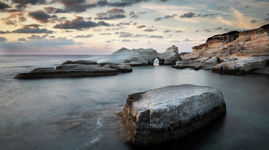 Rocky seashore seascape during sunset                    with wavy ocean at sea caves coastal are Photograph by Michalakis Ppalis