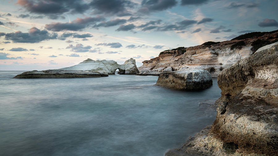 Rocky seashore seascape with wavy ocean and dramatic sunset Photograph by Michalakis Ppalis