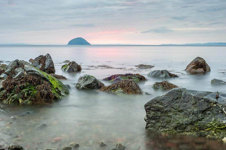 Rocky shore at Girvan-Ailsa craig Photograph by Photography by David A Johnson.