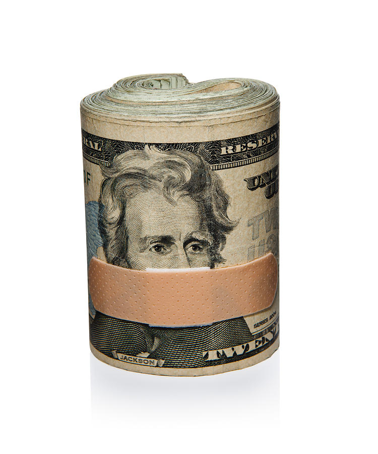Roll of cash with Band-Aid Photograph by James Worrell