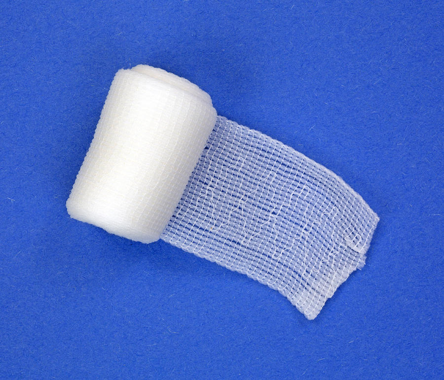 Roll of first aid gauze unrolling Photograph by BWFolsom