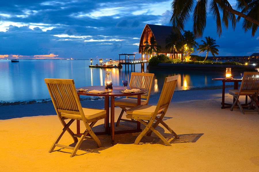 Romantic Candlelight Beach Dinner at Seaside Restaurant Photograph by PhotoTalk