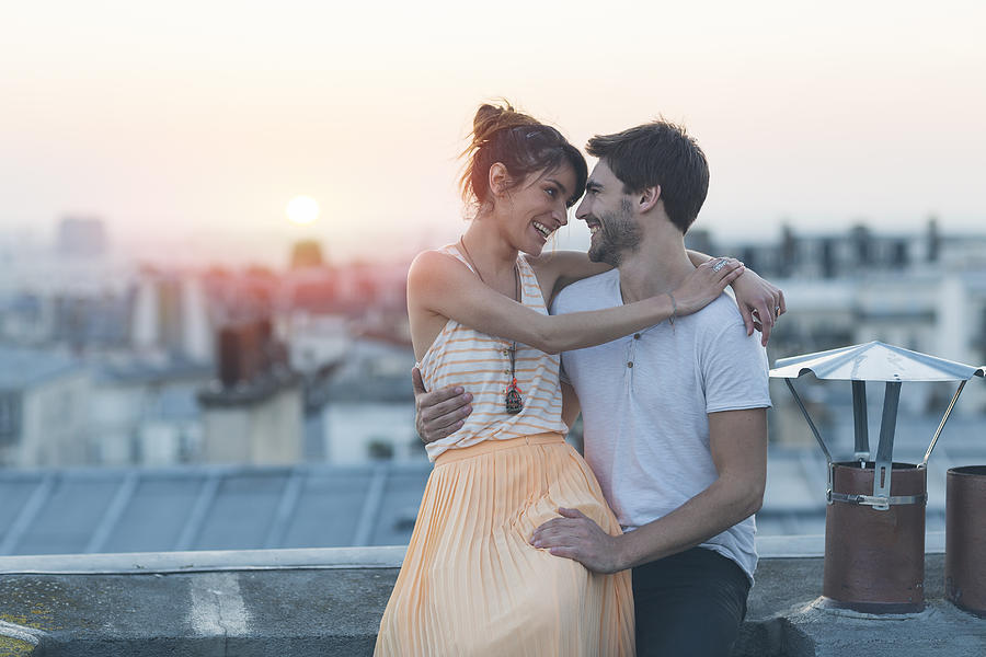 Romantic couple on rooftop, Paris Photograph by Sylvain Sonnet