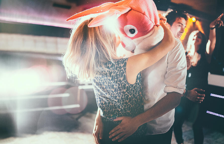 Romantic couple, with guy in a bunny head dancing together Photograph by Wundervisuals