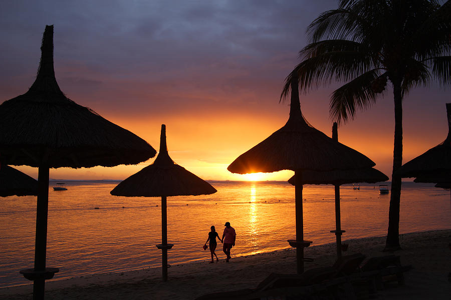 Romantic stroll at sunset on tropical beach. Photograph by Rosemary Calvert