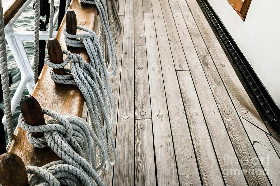 Ropes on a sailboat to tighten the sails of the ship during a cruise for tourists. Photograph by Joaquin Corbalan