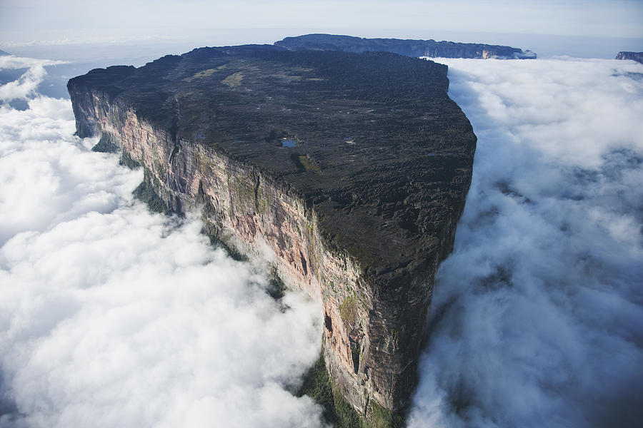 Roraima is the highest tepui reaching 2810 meters in elevation. These cloud covered flat top mountains are considered to be some of the oldest geological formations on Earth, Venezuela, South America Photograph by Martin Harvey
