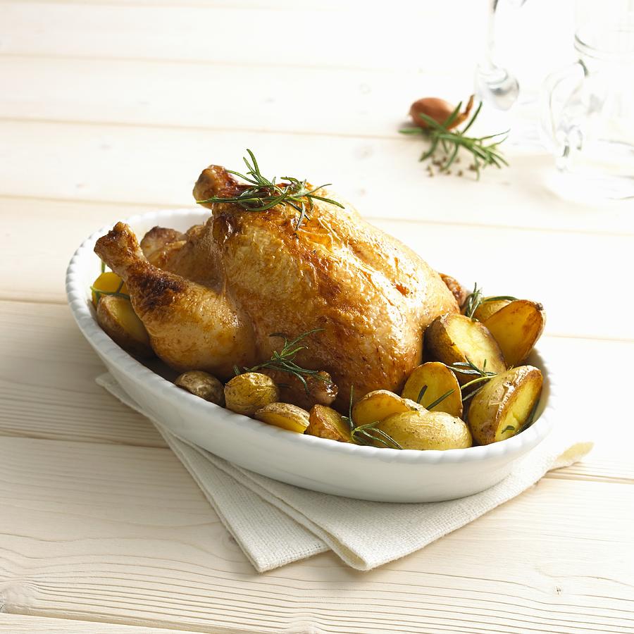 Rosemary chicken with oven potatoes Photograph by StockFood