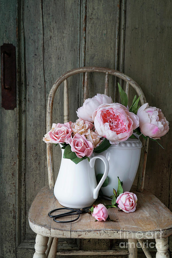 Roses and peonies in white vases on rustic old chair Photograph by Sandra Cunningham