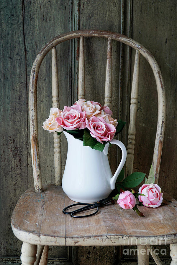 Roses in white vase on rustic old chair Photograph by Sandra Cunningham