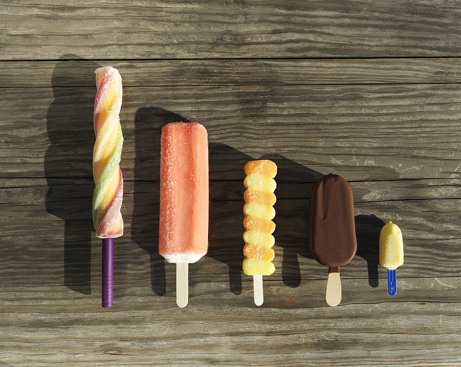 Row of assorted ice cream lollies Photograph by Henrik Sorensen