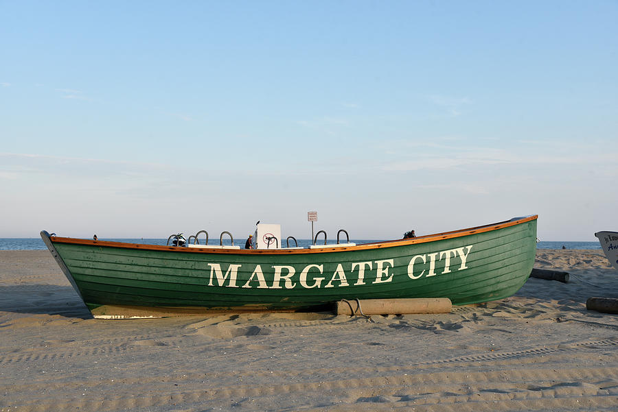 Rowboat marks the section of beach belonging to Margate New Jers Photograph by Mark Stout