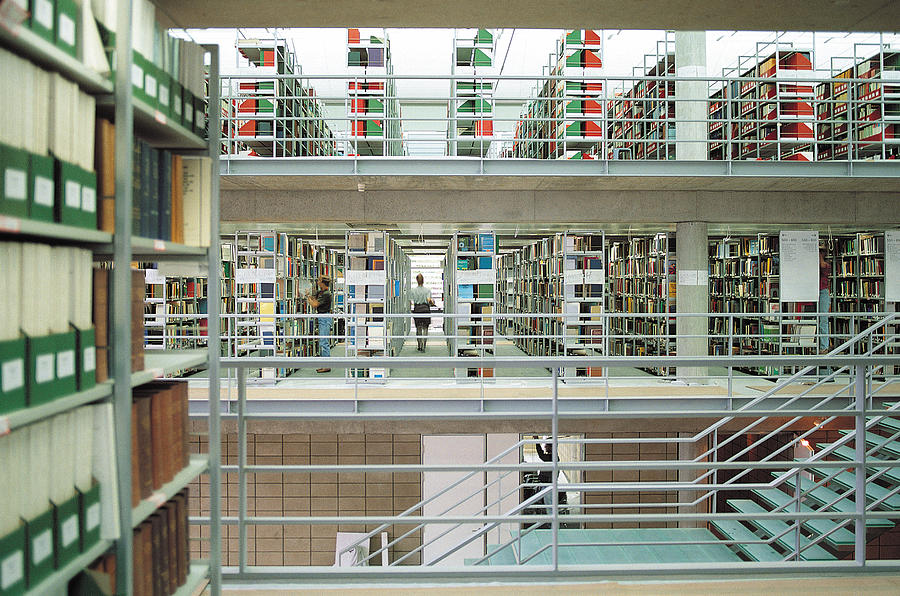 Rows of bookshelves in library Photograph by Tony Weller