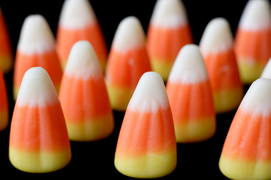 Rows of Candy Corns on Black Background Photograph by Saturated