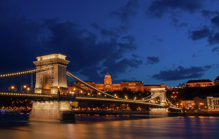 Royal Palace or the Buda Castle and the Chain Bridge after sunset in Budapest in Hungary. Photograph by Michalakis Ppalis