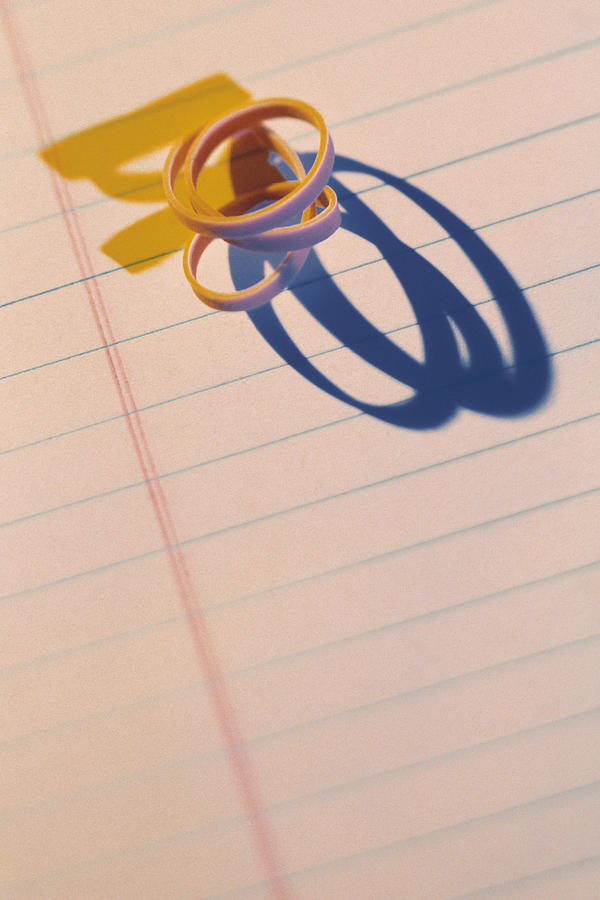 Rubber band on notepad Photograph by Comstock